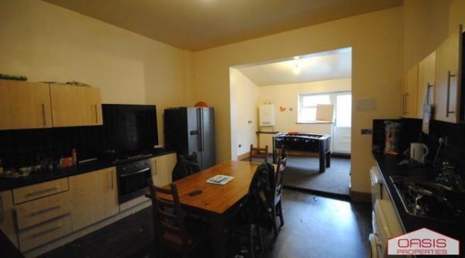 A spacious and well-lit living room featuring m...