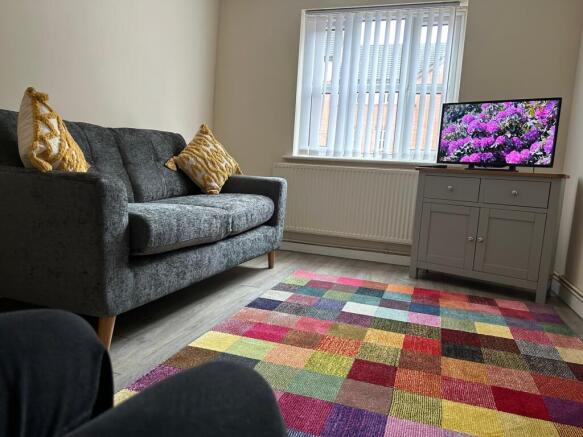 A bright and inviting living room with cozy sea...