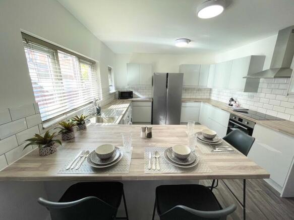 Bright modern kitchen with a large breakfast ba...