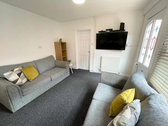 Bright, furnished living room with two comforta...