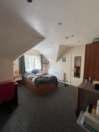 Bright, well-appointed bedroom with a double be...