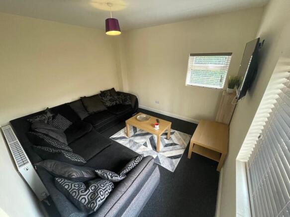 Bright corner living room with a large L-shaped...