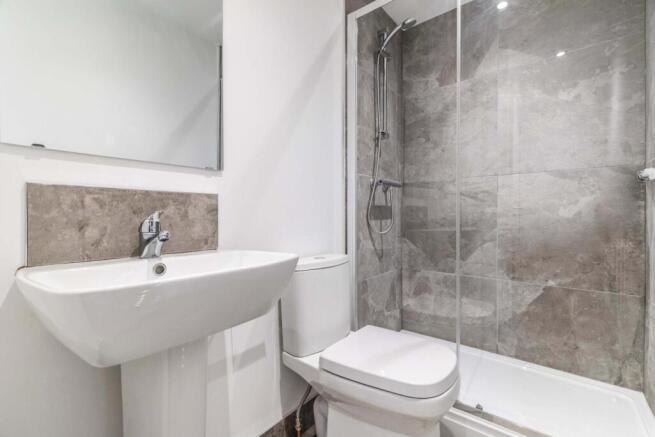 Modern ensuite bathroom with a walk-in glass sh...