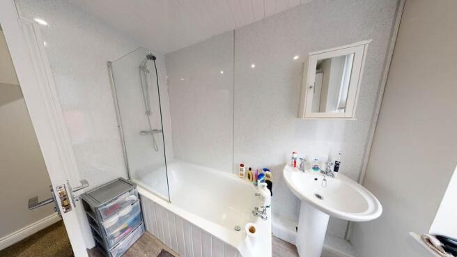 Bright modern bathroom with a shower-over-bath,...