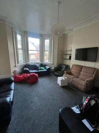 Bright communal lounge with a large bay window ...