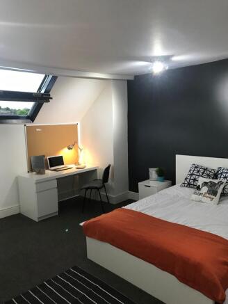 Bright, modern double bedroom with a comfortabl...