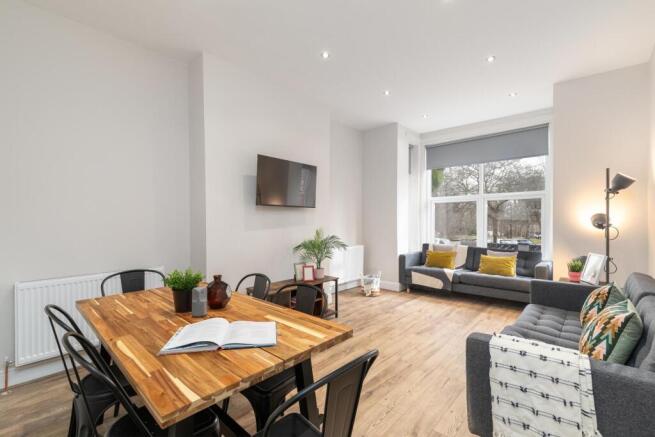 Bright, modern living area with large front win...