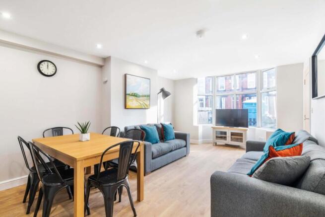 Bright, modern open-plan living area with large...