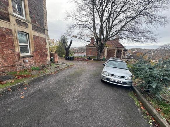 Gravel driveway and parking area beside a perio...
