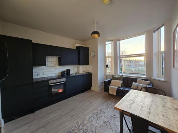 Bright open-plan living area with a modern fitt...