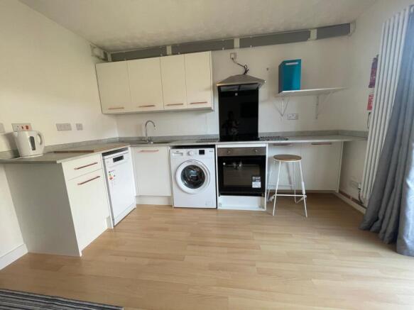 A bright and modern kitchenette featuring essen...