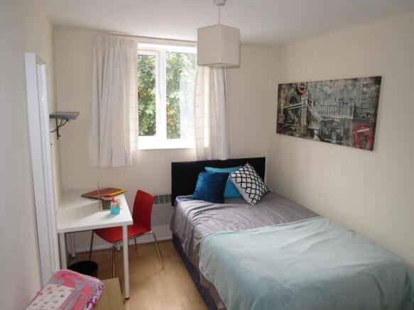 A bright and cozy double bedroom with a stylish...