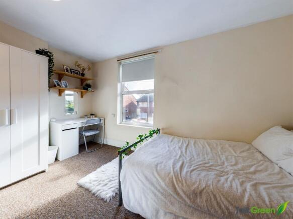 Bright, neatly styled double bedroom with a com...