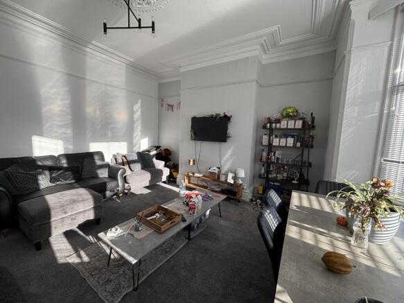 Bright, well-presented living room with large w...