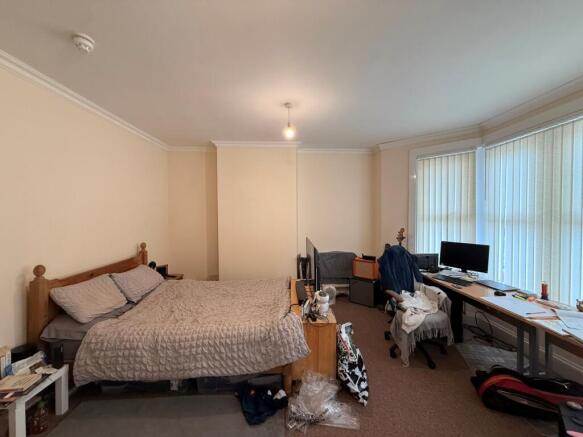 Spacious, airy bedroom with a large double bed,...
