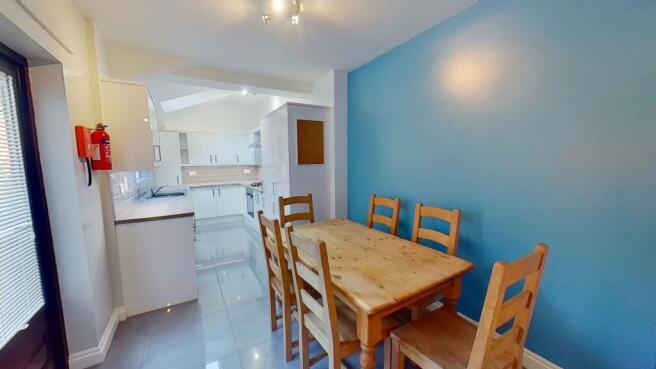 Bright open-plan kitchen and dining area with a...