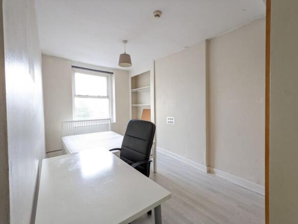 Bright, simply furnished bedroom with a large w...