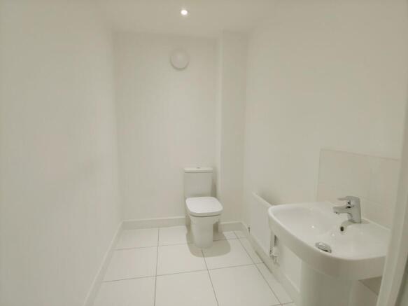 Bright, modern white bathroom with a sleek pede...