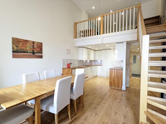 Bright open-plan living and dining area with hi...