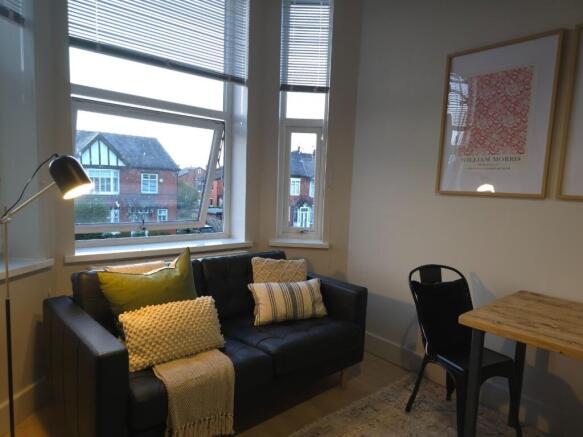 Bright, cosy living area with a comfortable two...