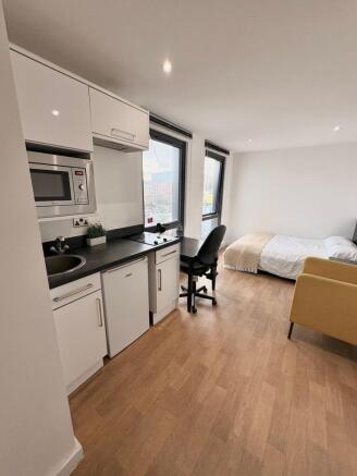 Bright, modern studio with a compact fitted kit...