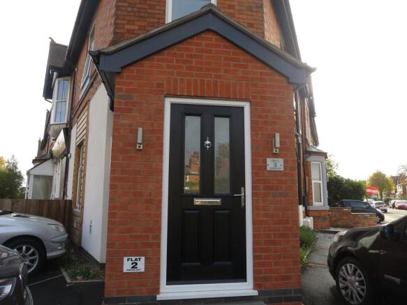 Well-maintained brick front entrance with a sty...