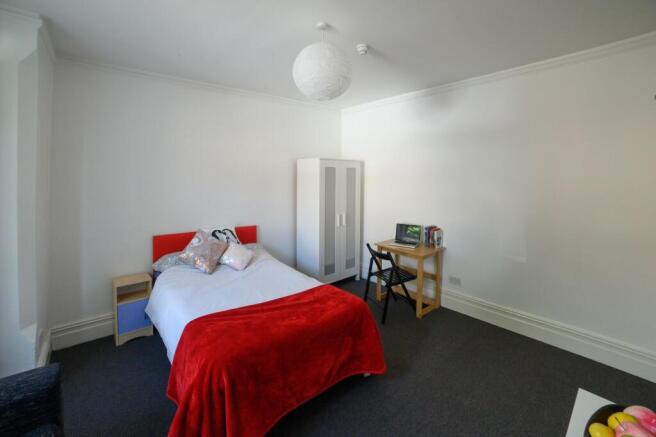 Bright, simply styled bedroom with a comfy doub...