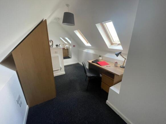 Bright attic single bedroom with three skylight...