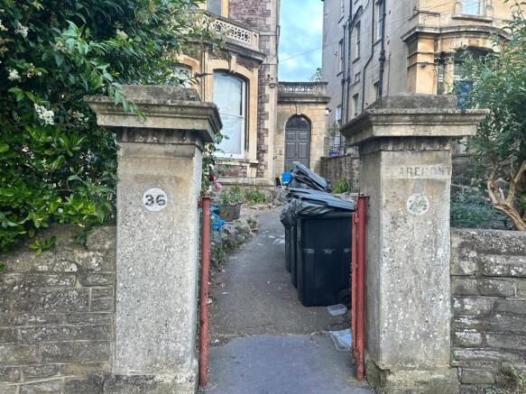 Stone entrance pillars and pathway leading up t...