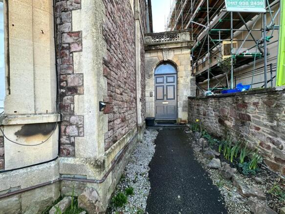 Attractive stone-built entrance with an arched ...