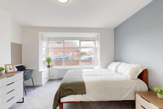 Bright and spacious master bedroom featuring a ...