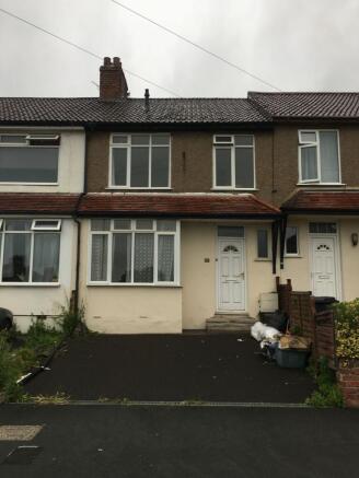 Terraced house exterior with a tiled roof, driv...