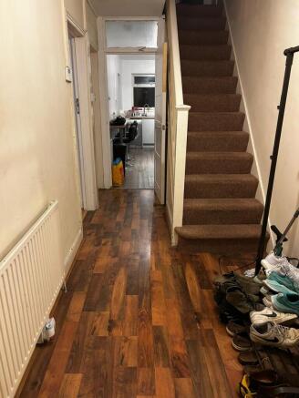 Welcoming entrance hallway with warm wood-effec...