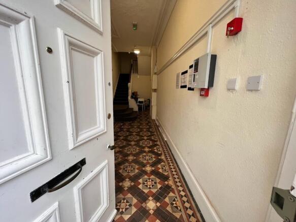 Welcoming entrance hallway with a patterned til...