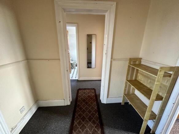 Bright hallway with neutral walls, fitted skirt...