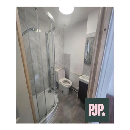 A modern bathroom suite featuring a spacious sh...