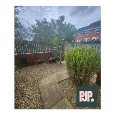 A charming garden space featuring a stone pathw...