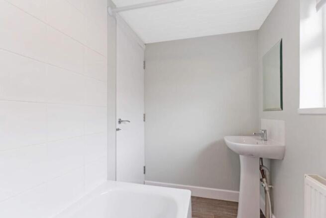 A modern bathroom featuring a sleek bathtub and...