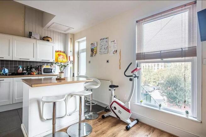 Bright and modern kitchen featuring a breakfast...