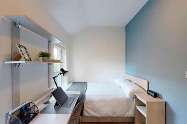 A bright and modern student bedroom featuring a...