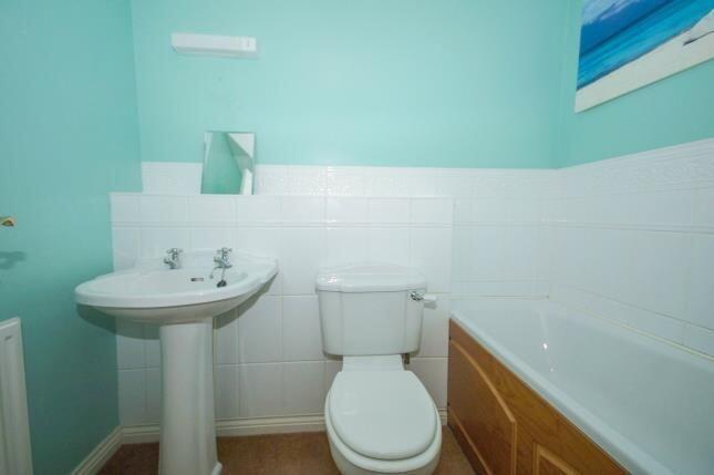 Bright bathroom with a classic white pedestal s...