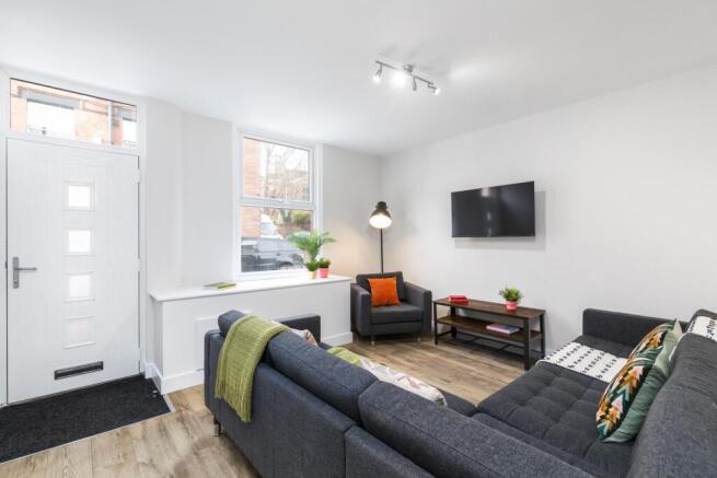 Bright, contemporary living room with a large L...