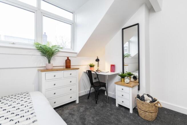 Bright, well-styled double bedroom with a large...