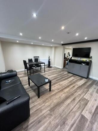 Contemporary open-plan living area with wood-ef...