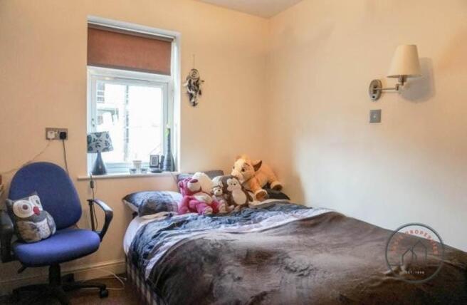 Cozy furnished bedroom with a double bed, soft ...