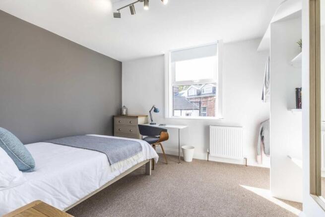 Bright, neatly presented bedroom with a comfort...