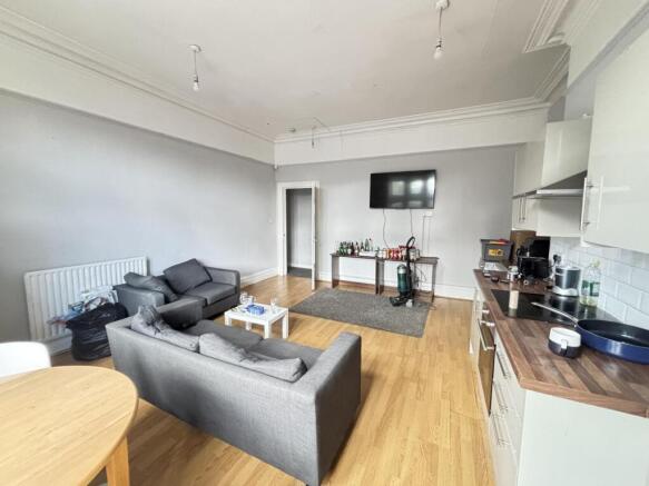 A spacious and modern living room featuring com...