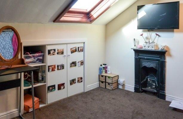 Bright attic double bedroom with a skylight, fi...