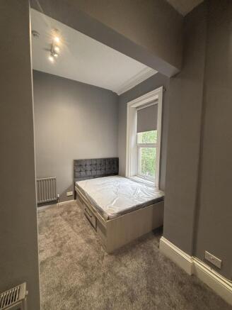 A well-lit, modern master bedroom featuring a l...