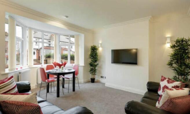 Bright, well-presented living room with a bay w...